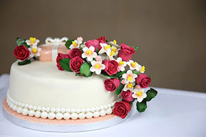 A decorated cake with flowers on top.